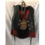 A MAN'S SCOTTISH TARTAN KILT, LEATHER WAISTCOAT AND SPORRAN