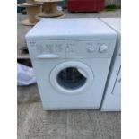 A WHITE INDESIT WASHING MACHINE