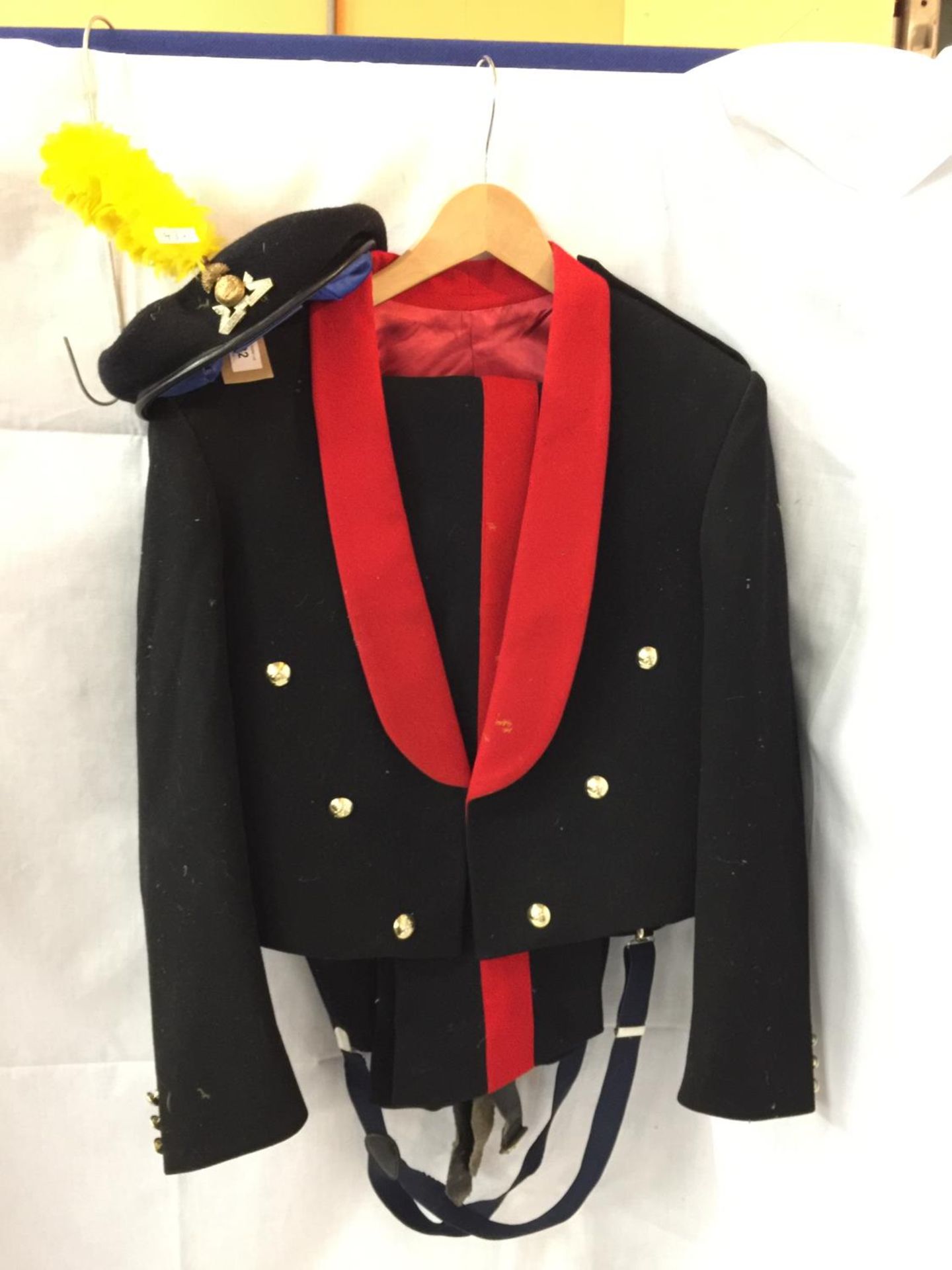 A ROYAL ARTILLERY MESS UNIFORM COMPRISING JACKET AND TROUSERS AND A LANCASHIRE FUSILIERS BERET