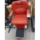 A MODERN ADJUSTABLE BARBERS CHAIR IN VIVID ORANGE