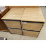 A PAIR OF LIMED OAK EFFECT TWO DRAWER FILING CABINETS COMPLETE WITH TWO KEYS