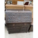 A HEAVILY CARVED OAK VICTORIAN BUREAU WITH LION MASK HANDLES, 34.5" WIDE