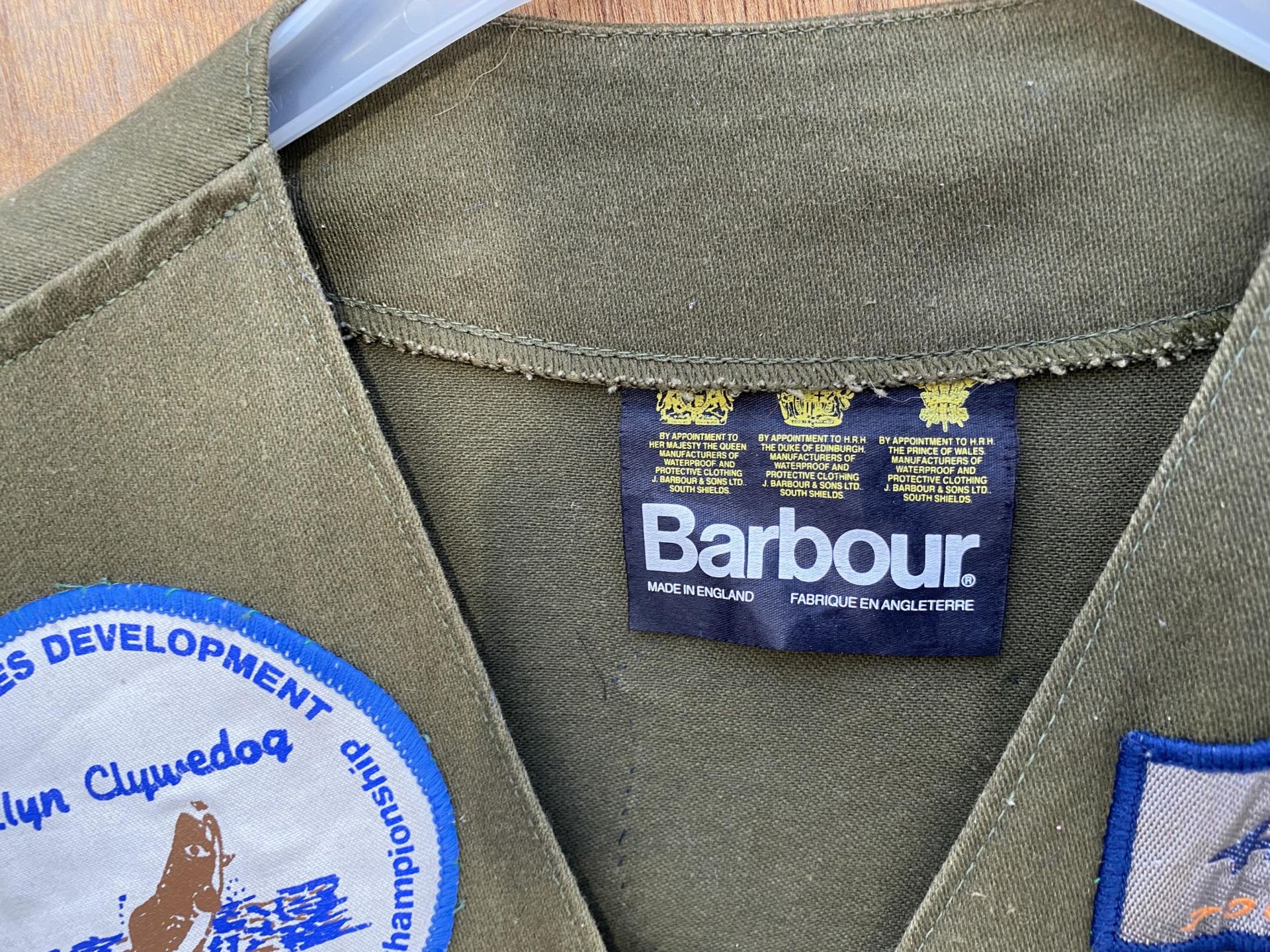 A PAIR OF BARBOUR ZIP UP BODY WARMERS DECORATED WITH VARIOUS FISHING BADGES AND TO ALSO INCLUDE - Image 4 of 4