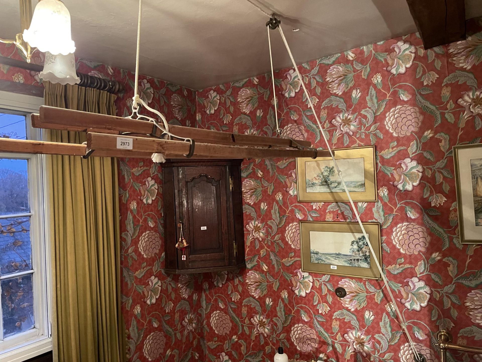 A CEILING SUSPENDED CAST IRON AND PINE CLOTHES AIRER