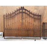 A PAIR OF IMPRESSIVE AND DECORATIVE WROUGHT IRON GARDEN GATES WITH CURVED TOPO AND TURNED DECORATION
