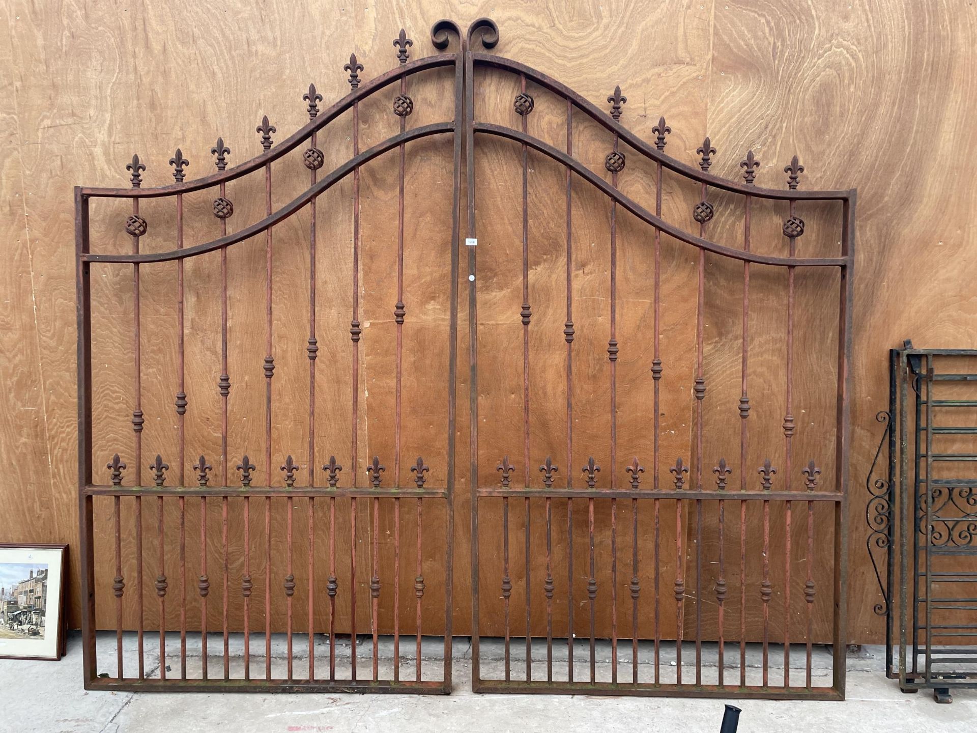 A PAIR OF IMPRESSIVE AND DECORATIVE WROUGHT IRON GARDEN GATES WITH CURVED TOPO AND TURNED DECORATION