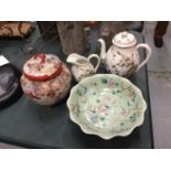 FOUR ORIENTAL ITEMS TO INCLUDE A DECORATED LIDDED JAR, AND A MATCHING TEAPOT AND JUG WITH SCENES