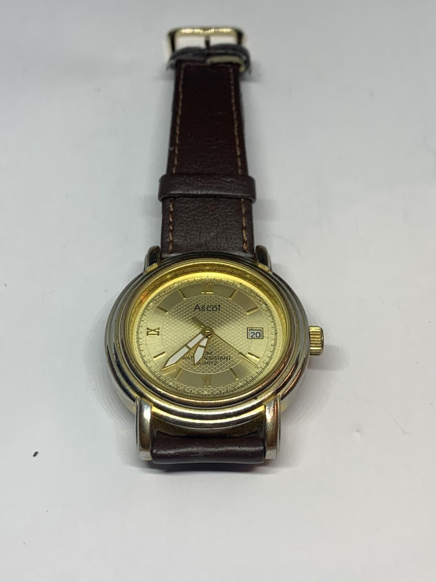 AN ASCOT CALENDAR WRIST WATCH WITH BROWN LEATHER STRAP SEEN WORKING BUT NO WARRANTY