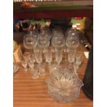 A COLLECTION OF GLASSWARE TO INCLUDE LARGE WINE GLASSES, CHAMPAGNE FLUTES, DISH ETC