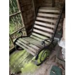 A SLATTED GARDEN ROCKER WITH CAST ENDS