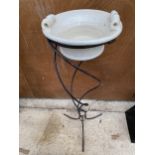 A VINTAGE CERAMIC WASH BOWL ON A DECORATIVE TURNED WROUGHT IRON STAND
