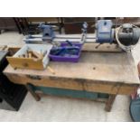 A RECORD WOOD TURNING LATHE ON A WORKBENCH BASE WITH AN ASSORTMENT OF LATHE TOOLS