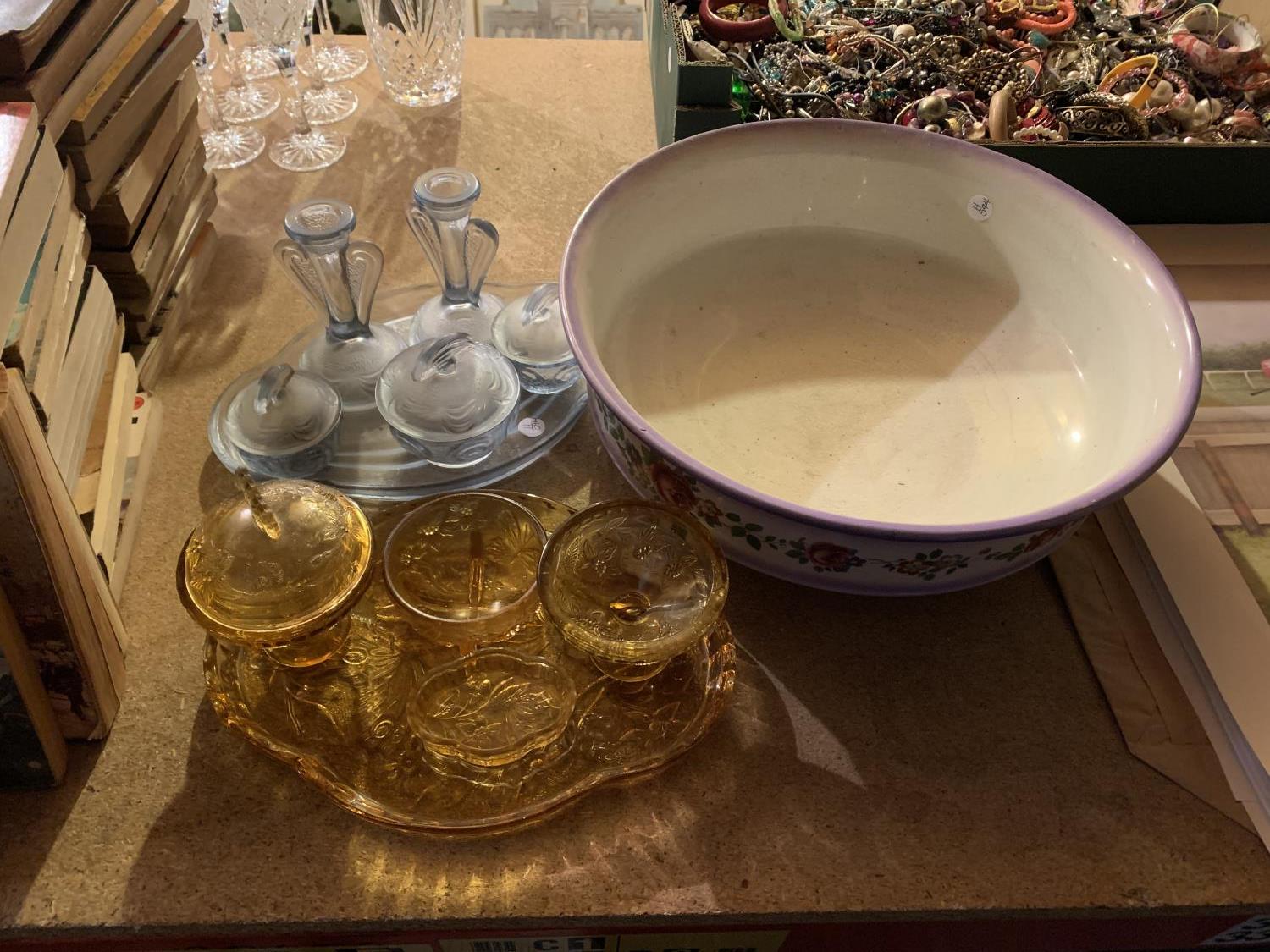 A PALE BLUE GLASS DRESSING TABLE SET, AN AMBER DRESSING TABLE SET AND A LARGE FLORAL DECORATED