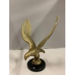 A BRASS EAGLE ON A PLINTH