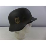 A GERMAN GREEN PAINTED METAL HELMET WITH SS RUNES DECAL AND HAVING BROWN LEATHER LINING