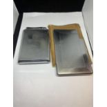 TWO WHITE METAL CIGARETTE CASES ONE WITH A POUCH AND ONE WITH AN INTEGRATED COLIBRI LIGHTER