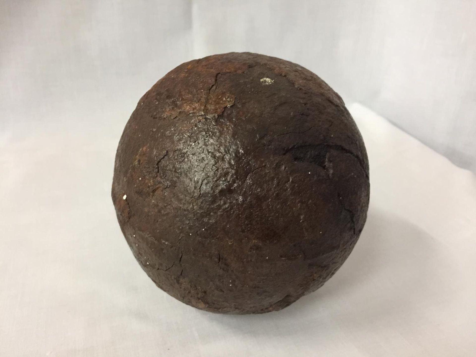 A LARGE CANNON BALL FROM H.M.S. ASSOCIATION WHICH SANK IN 1707