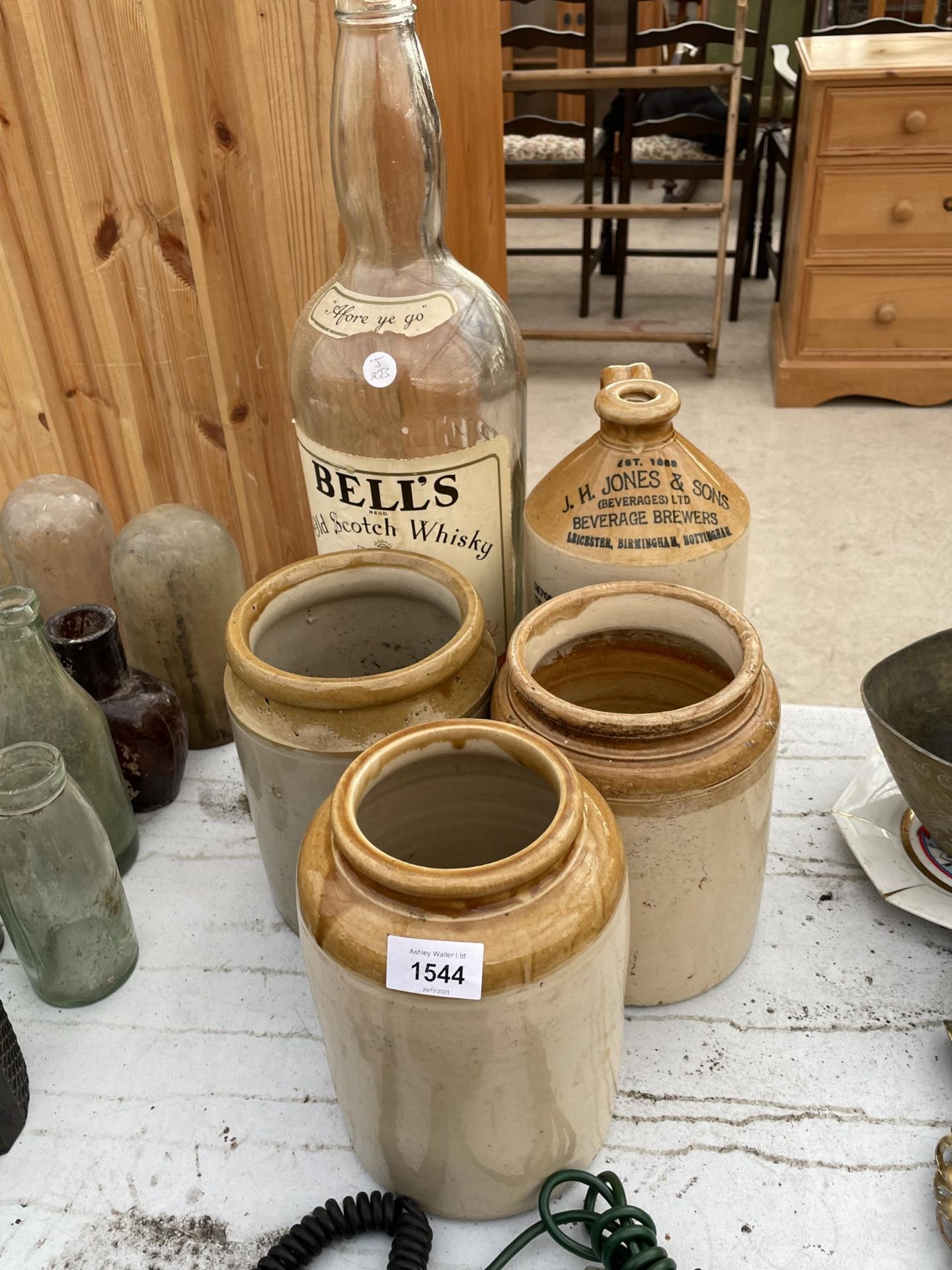 THREE VINTAGE STONEWARE VESSELS, A STONEWARE FLAGGON AND A LARGE BELLS WHISKEY BOTTLE