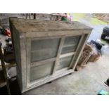 A PAINTED PINE BOOKCASE WITH SLIDING GLASS DOORS (W:124CM)