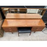 A RETRO TEAK AUSTINSUITE DRESSING TABLE AND STOOL, 66.5" WIDE