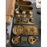 A COLLECTION OF BRASSWARE TO INCLUDE AN INKWELL, CANDLESTICKS, PLANTERS, FIGURES, ETC