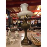A BRASS AND GLASS OIL LAMP CONVERTED TO A TABLE LAMP