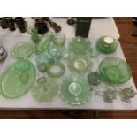 A LARGE AMOUNT OF GREEN GLASSWARE TO INCLUDE LEAF SHAPED BOWLS, PATTERNED PLATES, BOWLS, PLATES, ETC