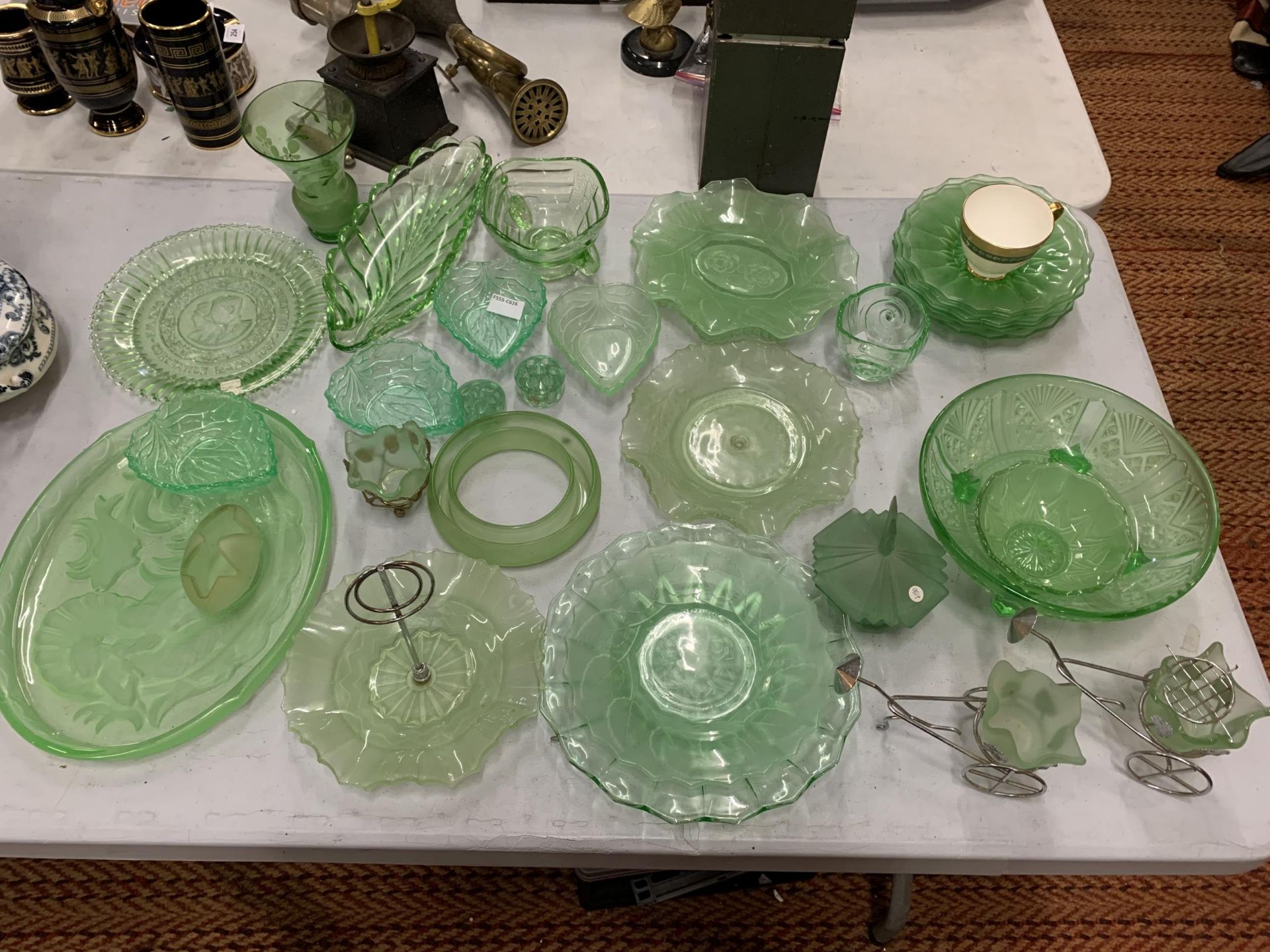 A LARGE AMOUNT OF GREEN GLASSWARE TO INCLUDE LEAF SHAPED BOWLS, PATTERNED PLATES, BOWLS, PLATES, ETC