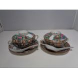 A PAIR OF ORIENTAL LIDDED BOWLS AND SAUCERS WITH SPOONS