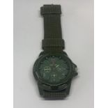 A SWISS ARMY WRISTWATCH WITH GREEN CANVAS STRAP SEEN WORKING BUT NO WARRANTY
