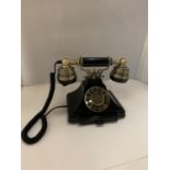 A VINTAGE STYLE BLACK AND BRASS PUSH BUTTON TELEPHONE WITH A PULL OUT NUMBER TRAY