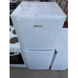 A WHITE BEKO UPRIGHT FRIDGE FREEZER {BELIEVED TO BE IN WORKING ORDER BUT NO GUARENTEE }