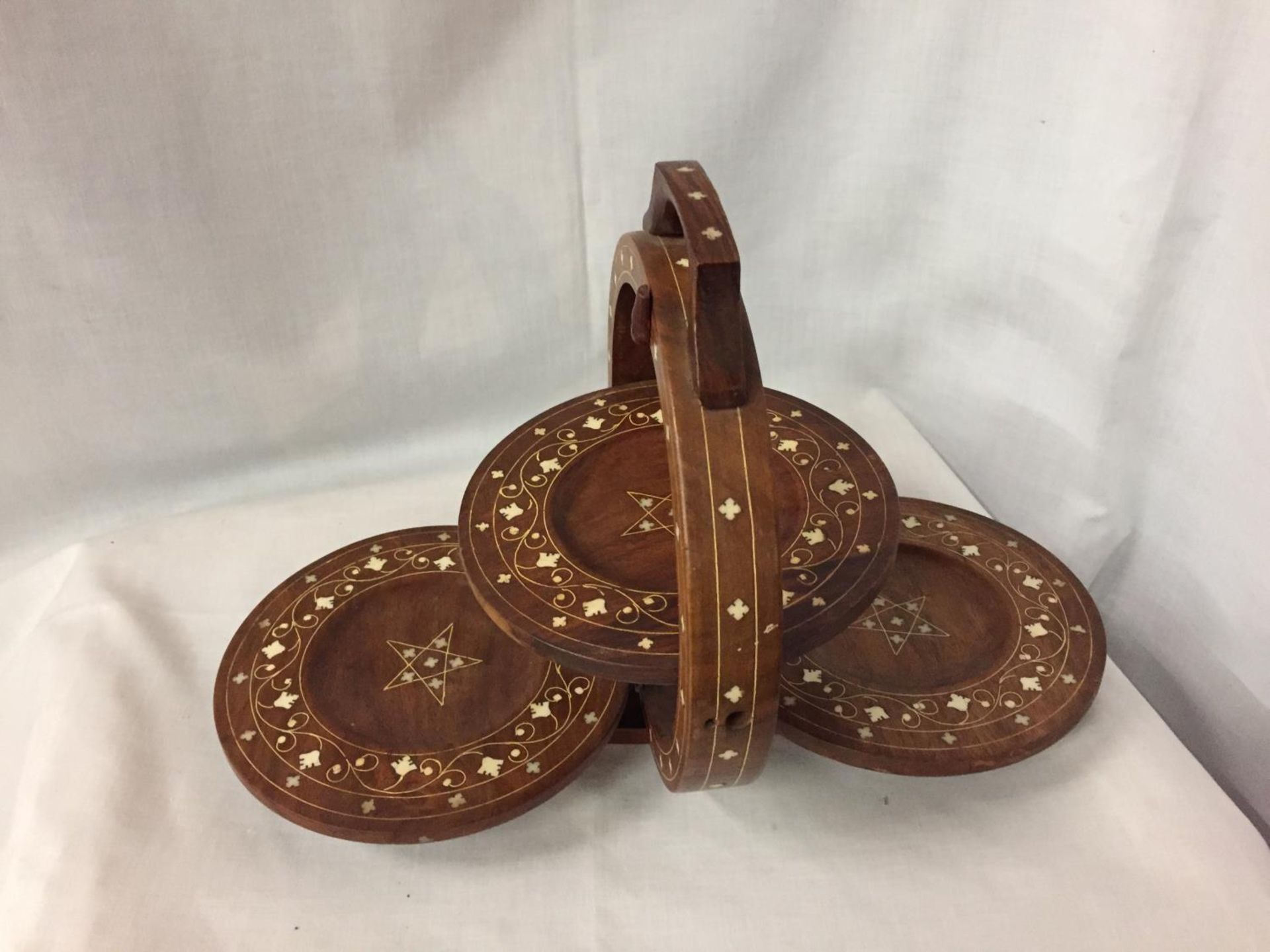 A THREE TIER INLAID MAHOGANY COLLAPSIBLE CAKE STAND