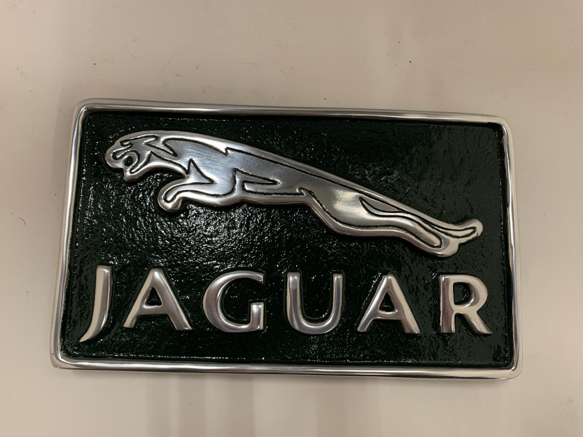 A GREEN CHROME JAGUAR SIGN, SIZE 29CM X 17CM