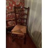 A LANCASHIRE STYLE OAK LADDER BACK DINING CHAIR WITH RUSH SEAT