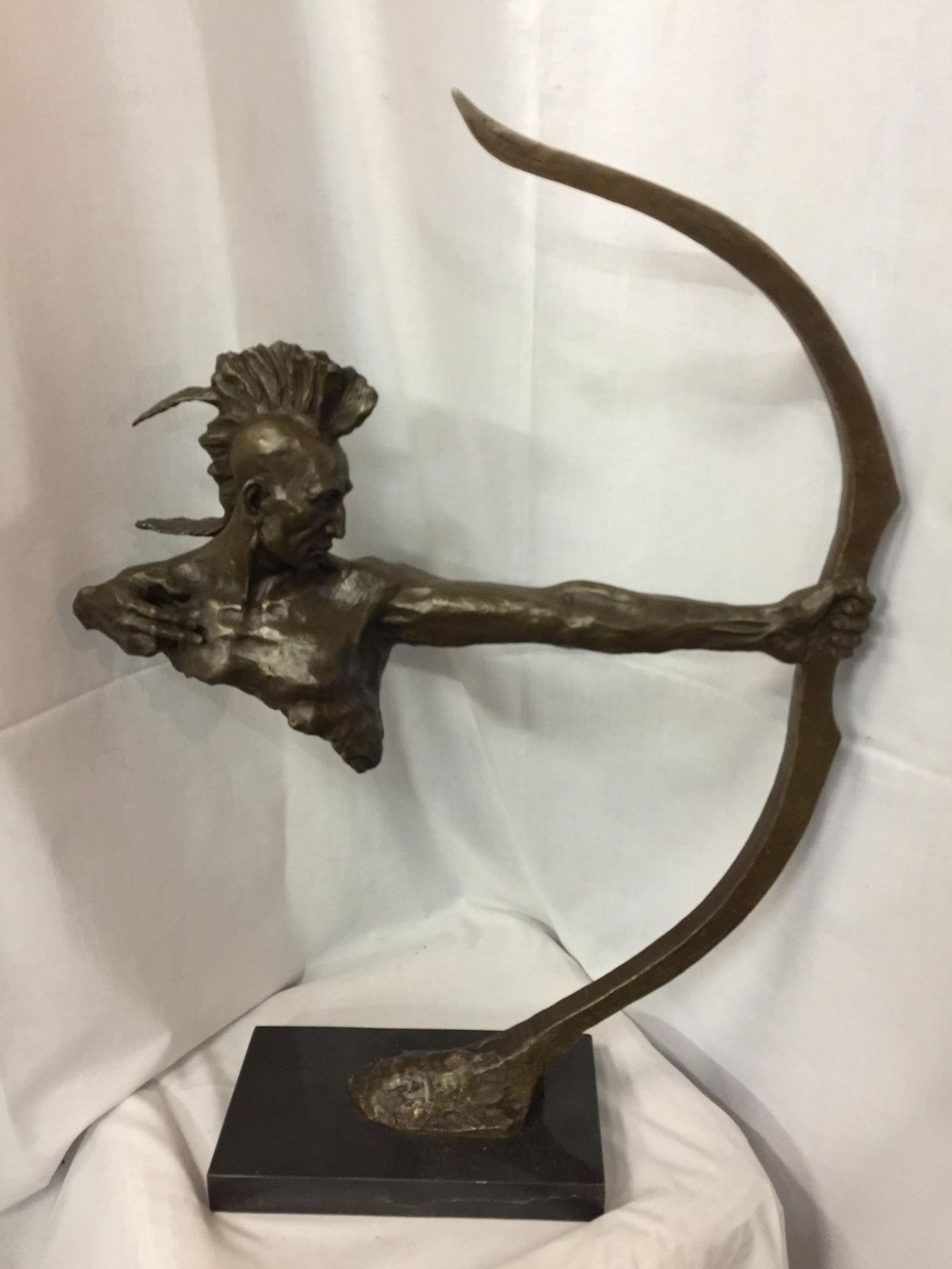 A LARGE BRONZE FIGURINE OF A RED INDIAN BUST HOLDING A BOW SIGNED NICK ON A MARBLE BASE