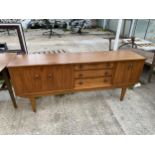 A RETRO TEAK SIDEBOARD ENCLOSING THREE DRAWERS AND THREE CUPBOARDS, WITH CIRCULAR TEAK DROP HANDLES