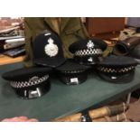 FIVE ASSORTED BRITISH POLICE HATS, TO INCLUDE GUERNSEY, LEEDS CITY, SCOTLAND ETC