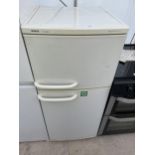 A WHITE BOSCH CLASSIX UPRIGHT FRIDGE FREEZER WITH INSTRUCTION MANUAL