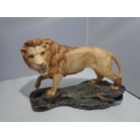 A BESWICK LION ON A ROCK