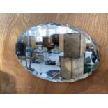 A DECORATIVE OVAL ART DECO BEVELED EDGE MIRROR