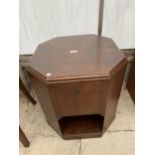 A MID 20TH CENTURY OAK OCTAGONAL TV TABLE WITH TWO STORAGE COMPARTMENTS, WITH DROP-DOWN DOORS