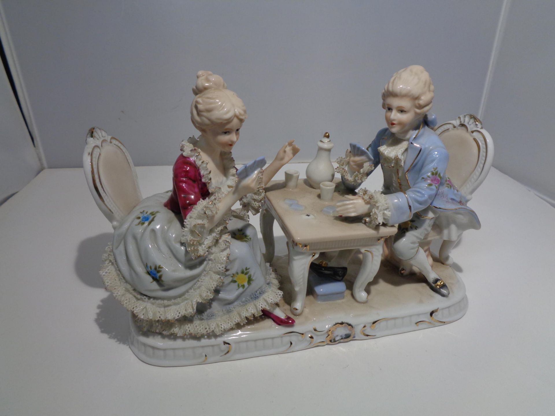 A VICTORIAN DRESDEN DOUBLE FIGURE OF A LADY AND GENT PLAYING CARDS