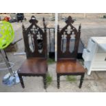 A PAIR OF VICTORIAN GOTHIC HALL CHAIRS ON TURNED LEGS, WITH LIDDED SEATS