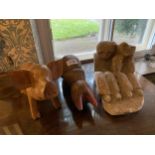 A HAND CARVED STONE SCULPTURE OF TWO FIGURES AND TWO WOODEN CARVINGS OF PIGS