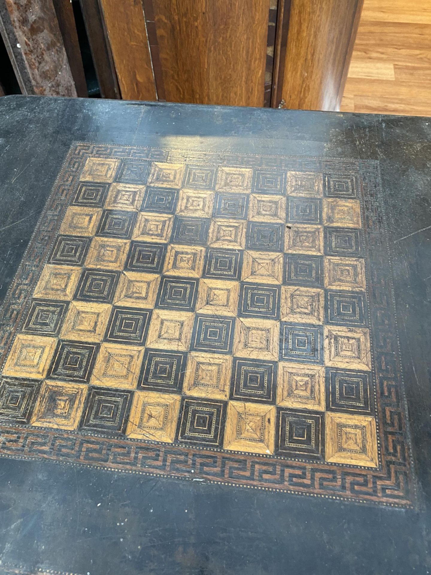 A VICTORIAN EBONISED GAMES TABLE WITH CHESS BOARD TOP AND TWO DRAWERS ON CARVED SUPPORTS 100CM X - Image 4 of 5