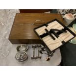 A WOODEN TWO SIDED CUTLERY BOX, SPOONS, KNIFE RESTS, ETC