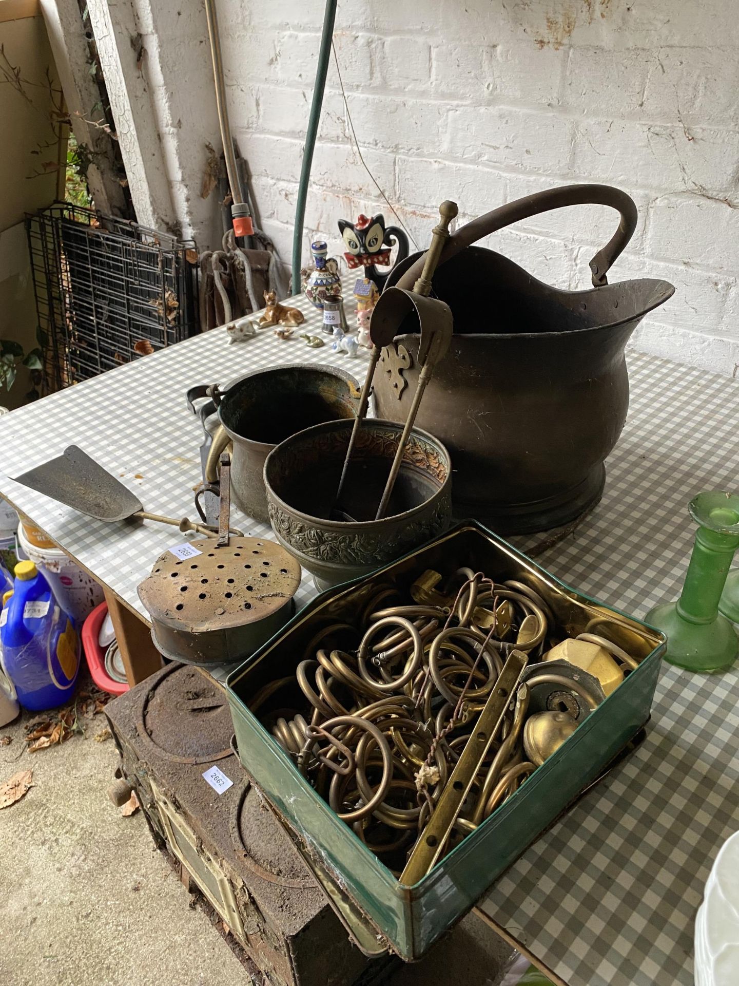 AN ASSORTMENT OF BRASS AND COPPER ITEMS TO INCLUDE A COAL BUCKET, FIRE SIDE ITEMS AND CURTAIN EYES