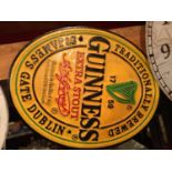 A ROUND CAST GUINNESS SIGN