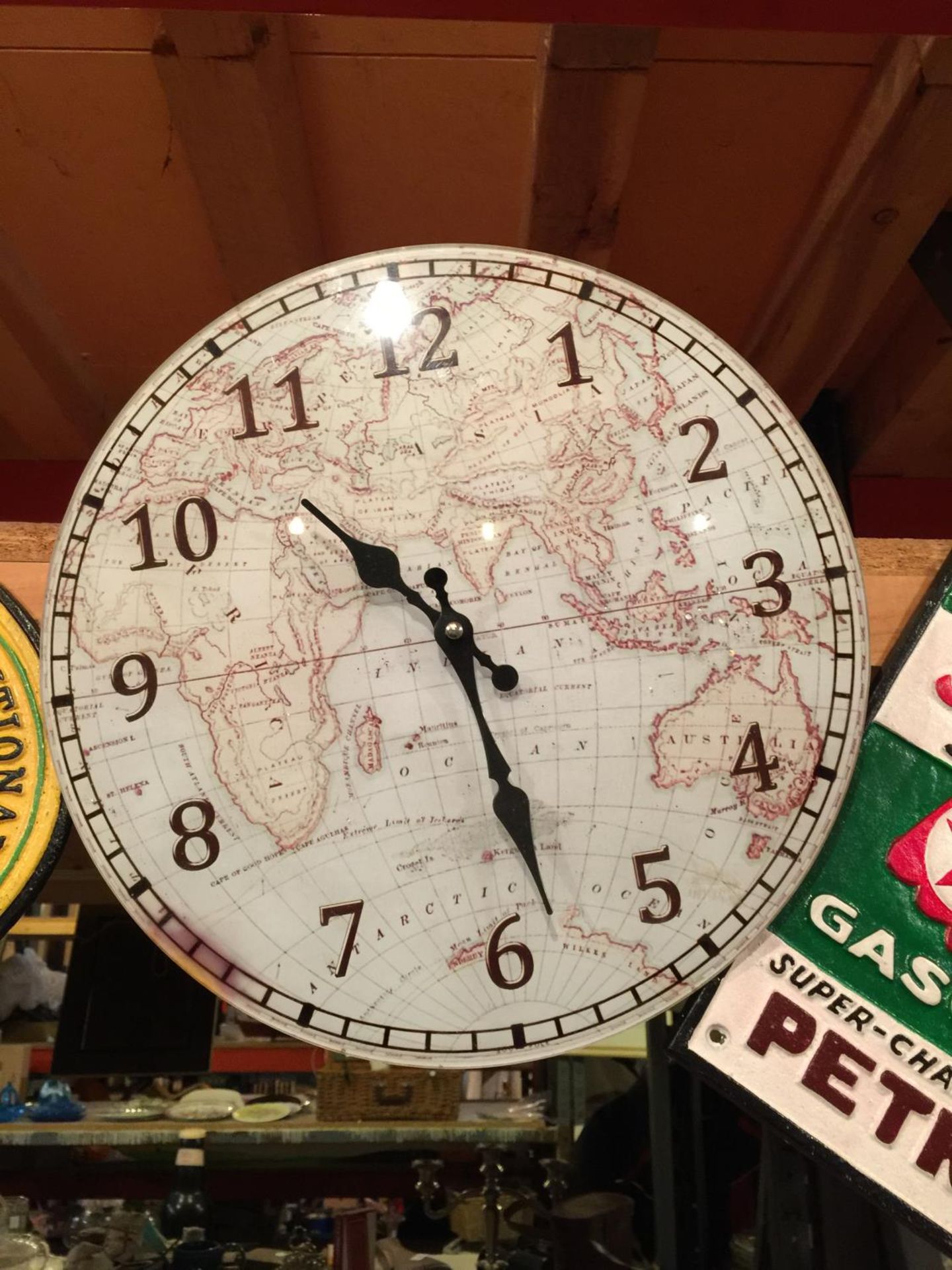 A GLASS FRONTED GLOBE/MAP STYLE WALL CLOCK